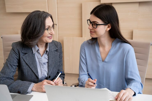 Women discussing in front of a computer